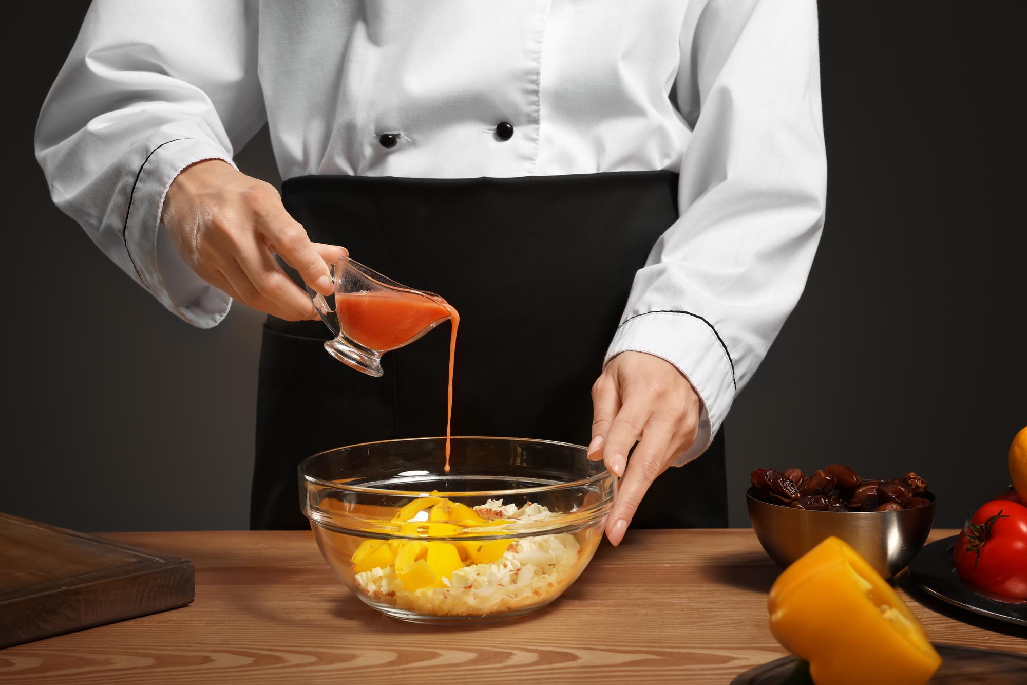 Chef hand preparing sauce in studio